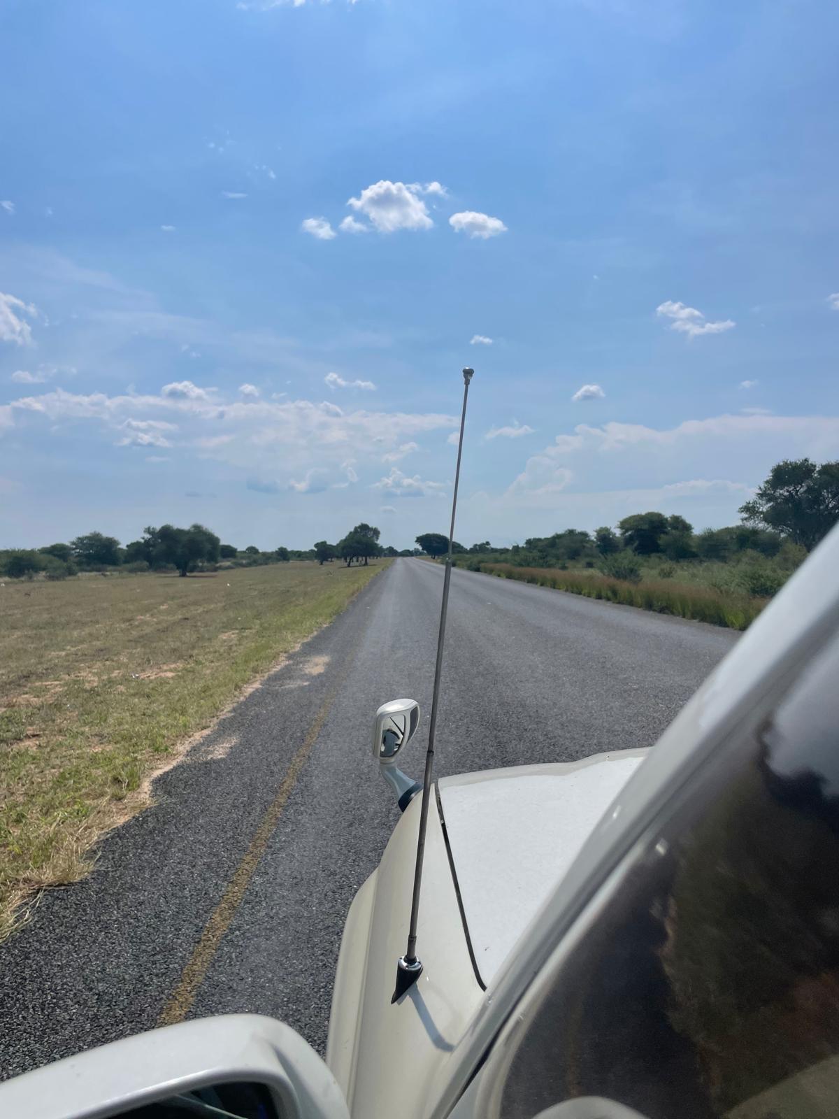 Trans-Kalahari Road — flat as far as the eye can see, greener than expected